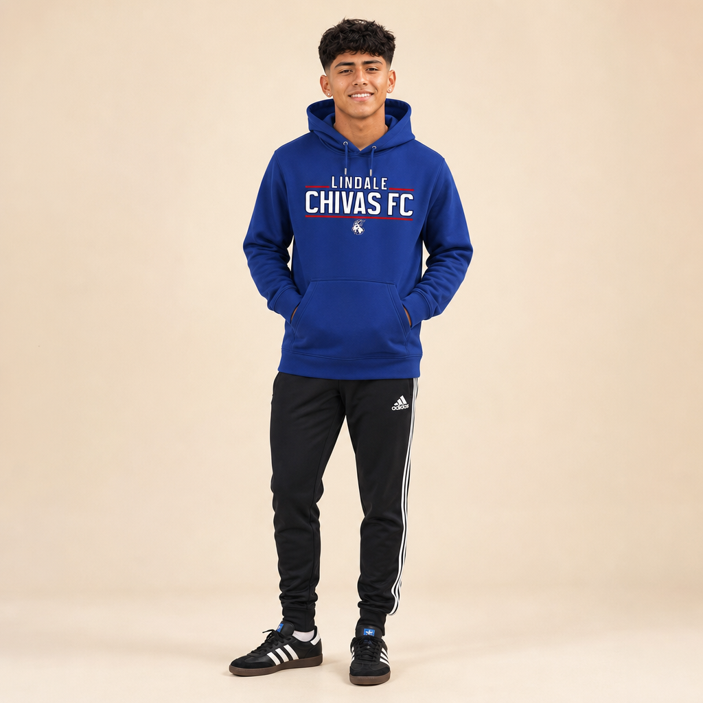 Soccer player wearing the Lindale Chivas Soccer Hoodie in True Royal, worn untucked over soccer pants with Adidas Sambas