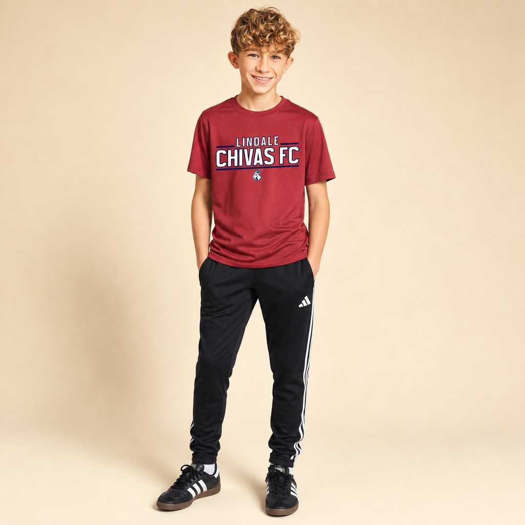 Boy wearing the Lindale Chivas Youth Dri-Fit Tee in True Red with Adidas soccer pants and Sambas