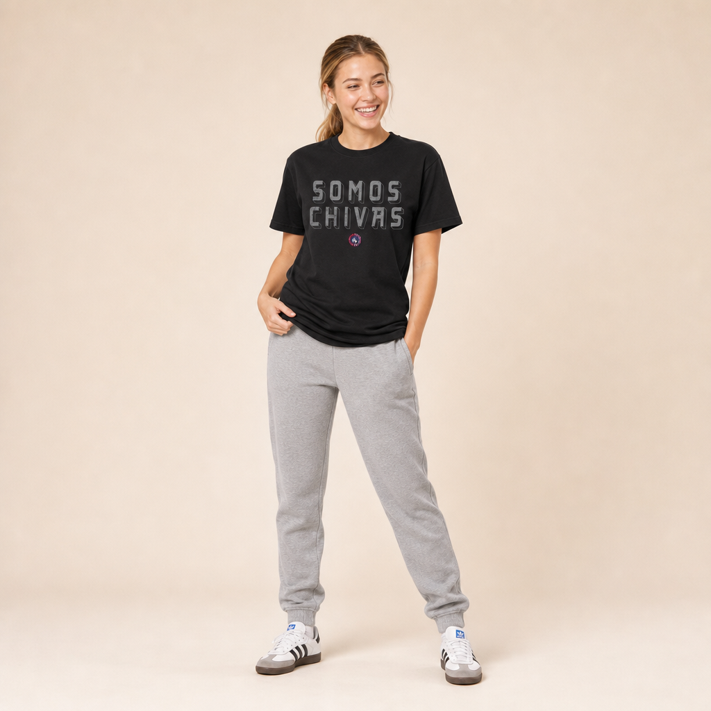 Woman wearing the Lindale Chivas Somos Chivas Tee in Black with grey joggers and Adidas Sambas
