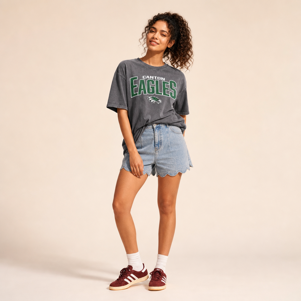 Canton Eagles Snow Washed Tee in pirate gray — Canton Eagles lockup and eagle mascot in green and white, worn by a model