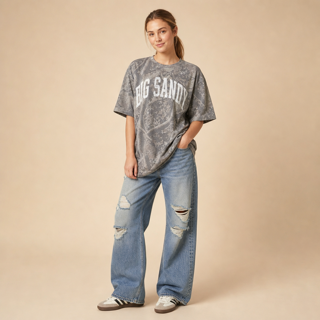 Big Sandy Premium Camo Tee — BIG SANDY in a white varsity arch on grey Deadwood Tree Camo, worn by a model