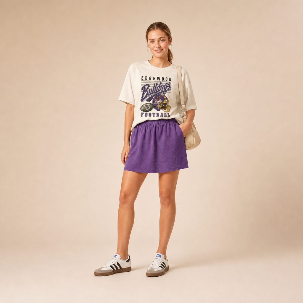 Edgewood Bulldogs Football Retro Tee — vintage helmet and Bulldogs script graphic in purple and gold, worn by a model