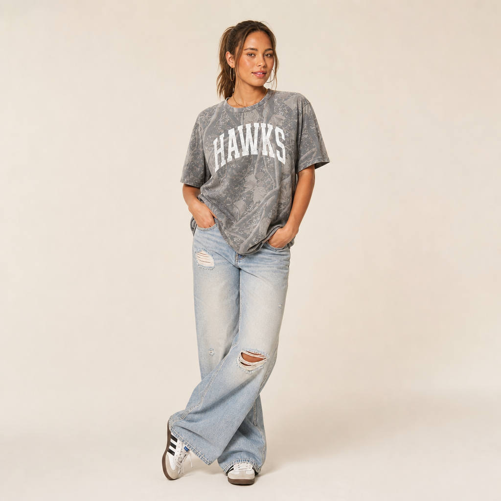 Hawkins Premium Camo Tee — HAWKINS in a white varsity arch on grey Deadwood Tree Camo, worn by a model