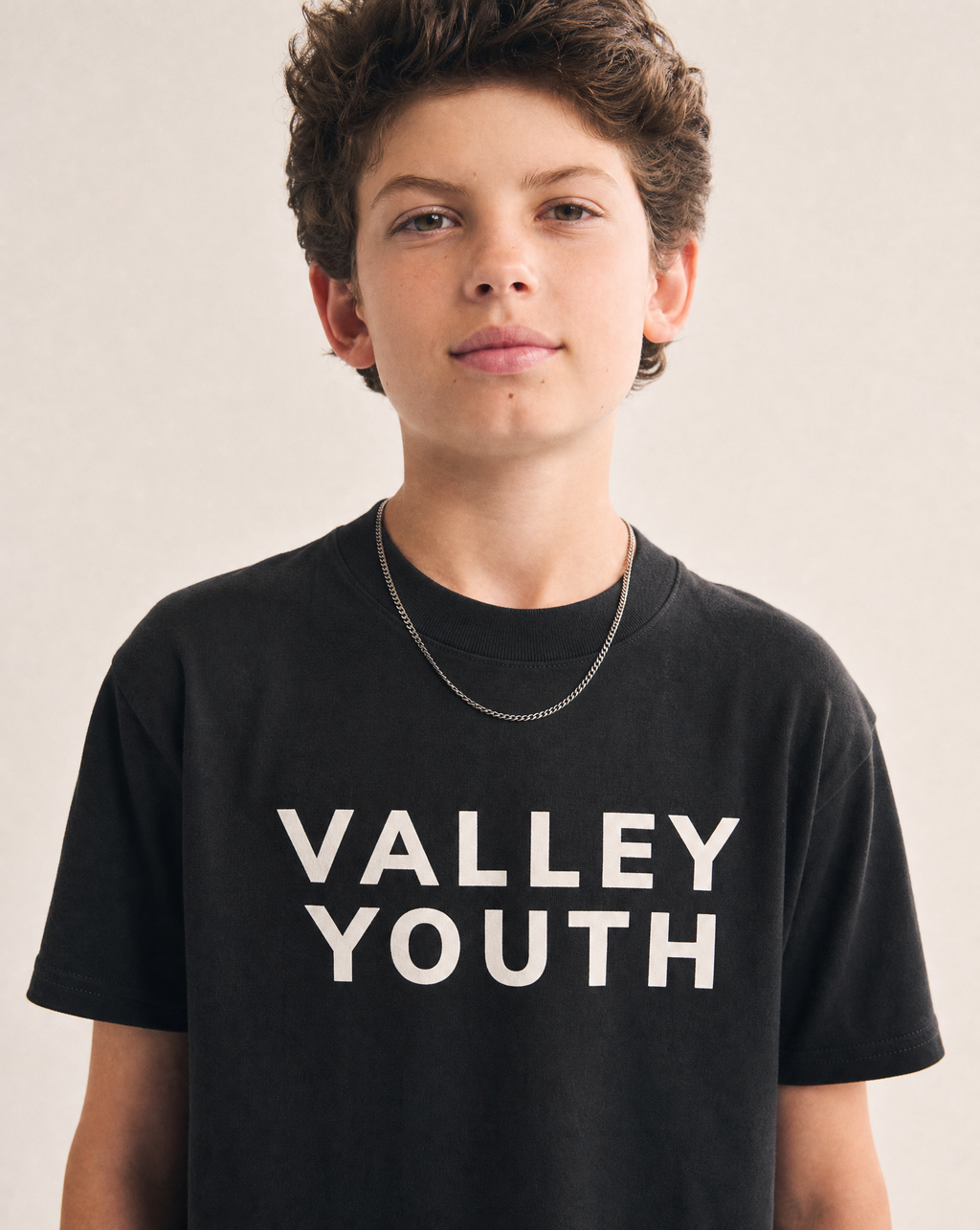 Valley Youth chest print close-up on black tee