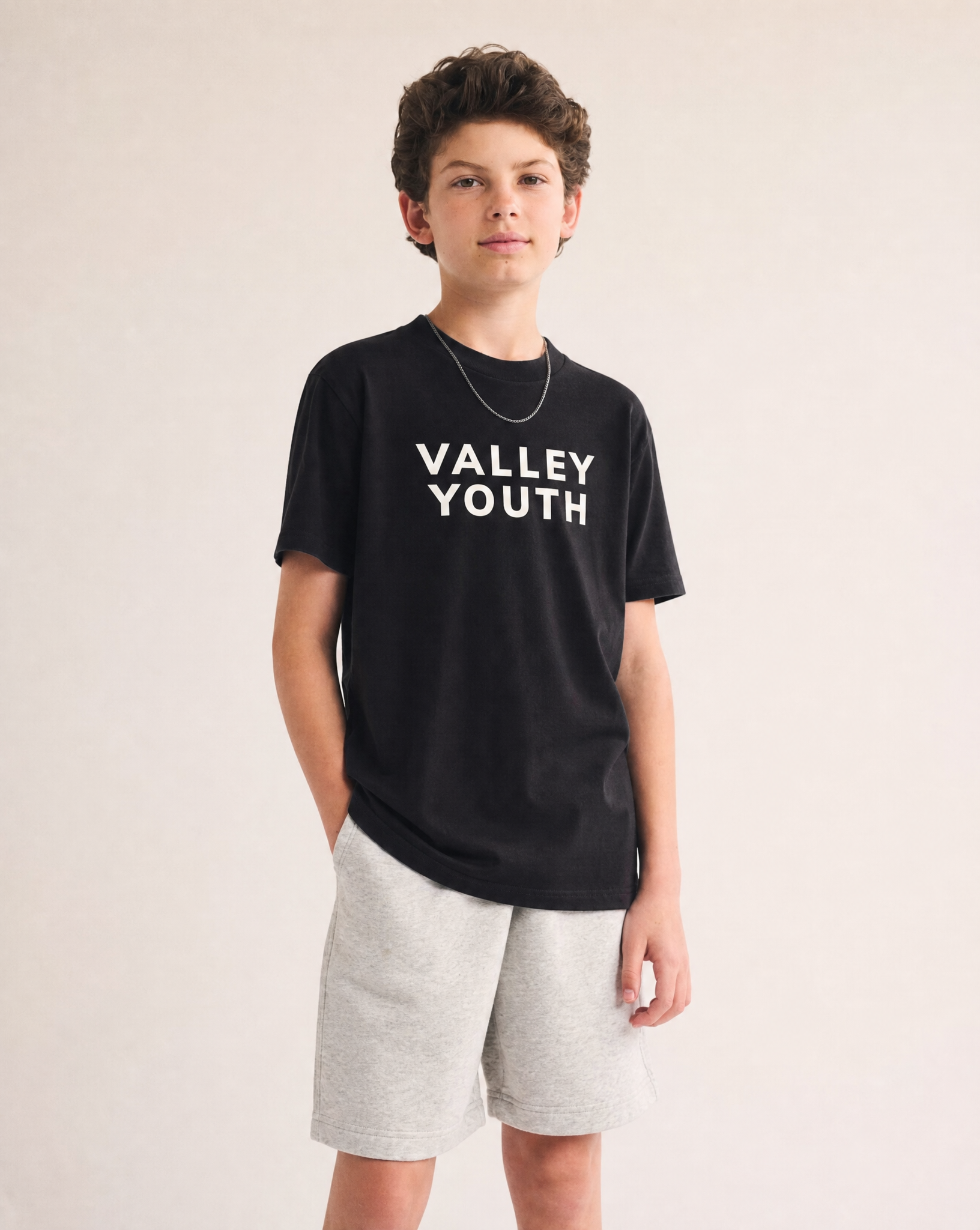 Valley Youth tee in black on youth model, front view
