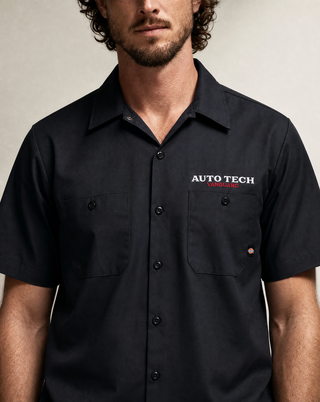 Vanguard Autotech chest logo close-up on black Dickies work shirt