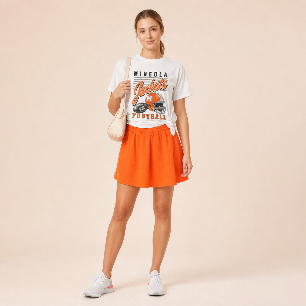 Mineola Jackets Football Retro Tee knotted at the side — vintage helmet and Jackets script graphic in orange, worn by a model