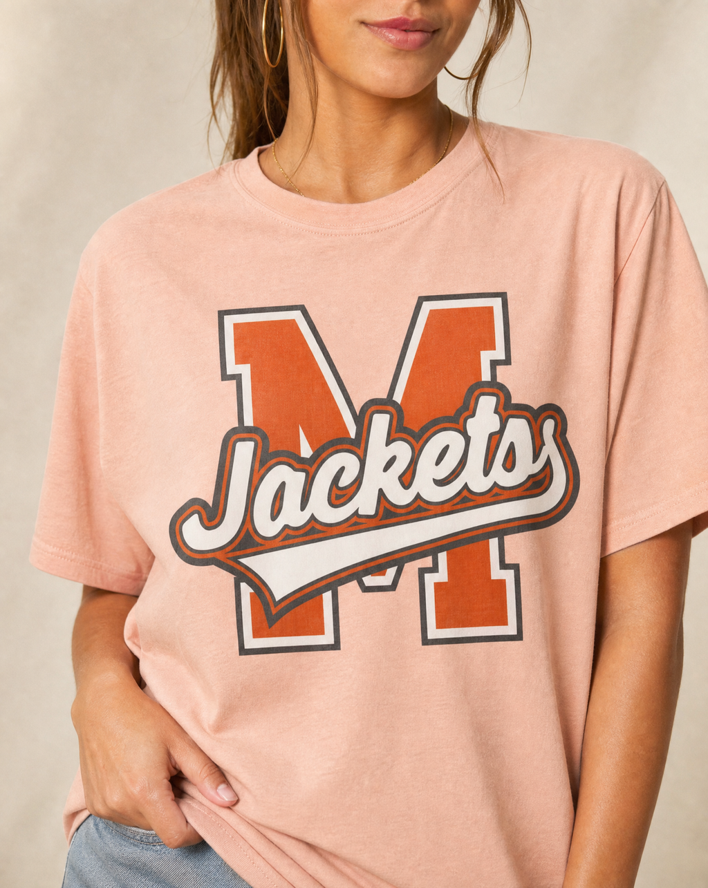 Close-up of the Mineola Jackets varsity print in Neon Cantaloupe