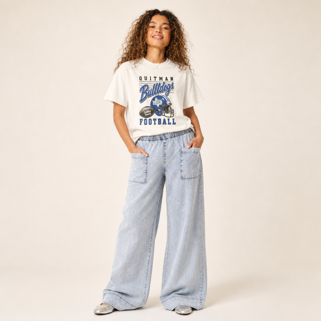 Quitman Bulldogs Football Retro Tee in ivory — vintage helmet and Bulldogs script graphic in blue, worn by a model
